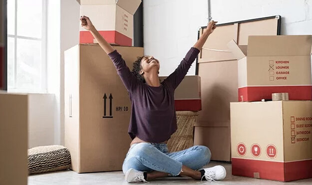 Young woman excited to pack storage boxes